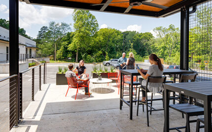Cline's Charlotte office, people on patio enjoying sunny day