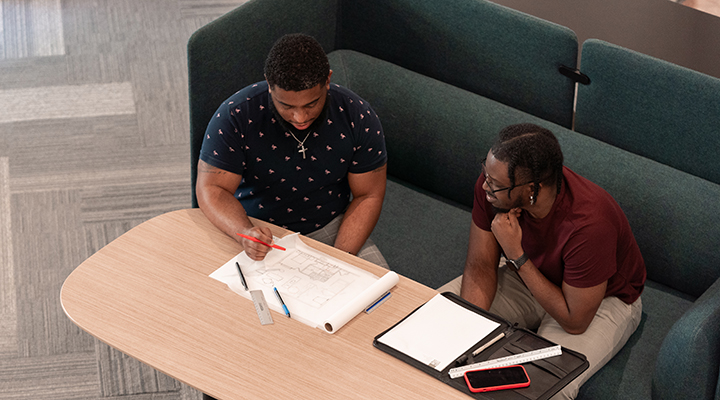 Two Raleigh Cline staff members working on a projecct